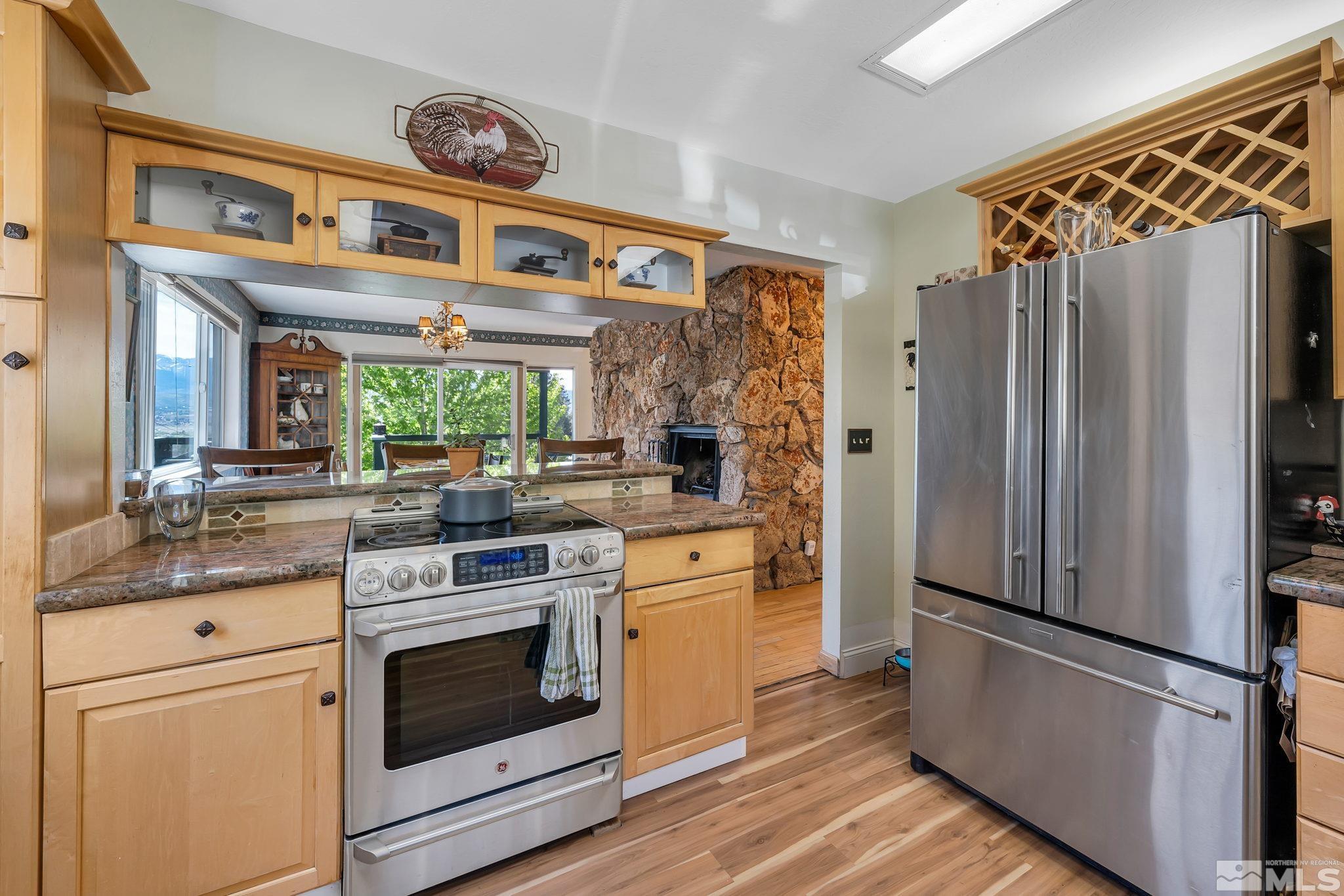 14615 Virginia Foothills Drive Reno, NV 89521 - Photo 19 of 27 a kitchen with stainless steel appliances granite countertop a refrigerator and a stove top oven