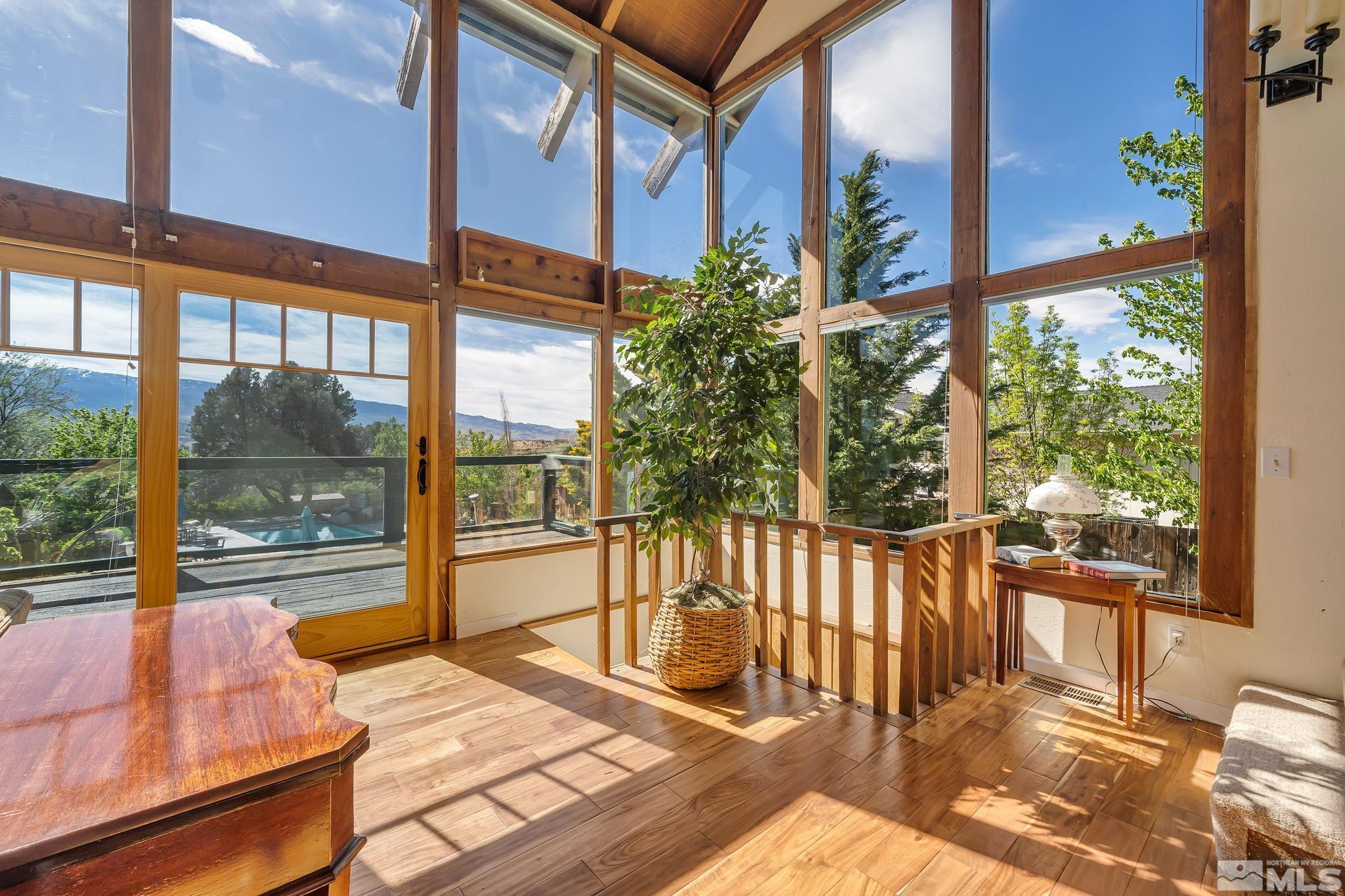 14615 Virginia Foothills Drive Reno, NV 89521 - Photo 8 of 27 a view of a balcony with a couch and wooden floor