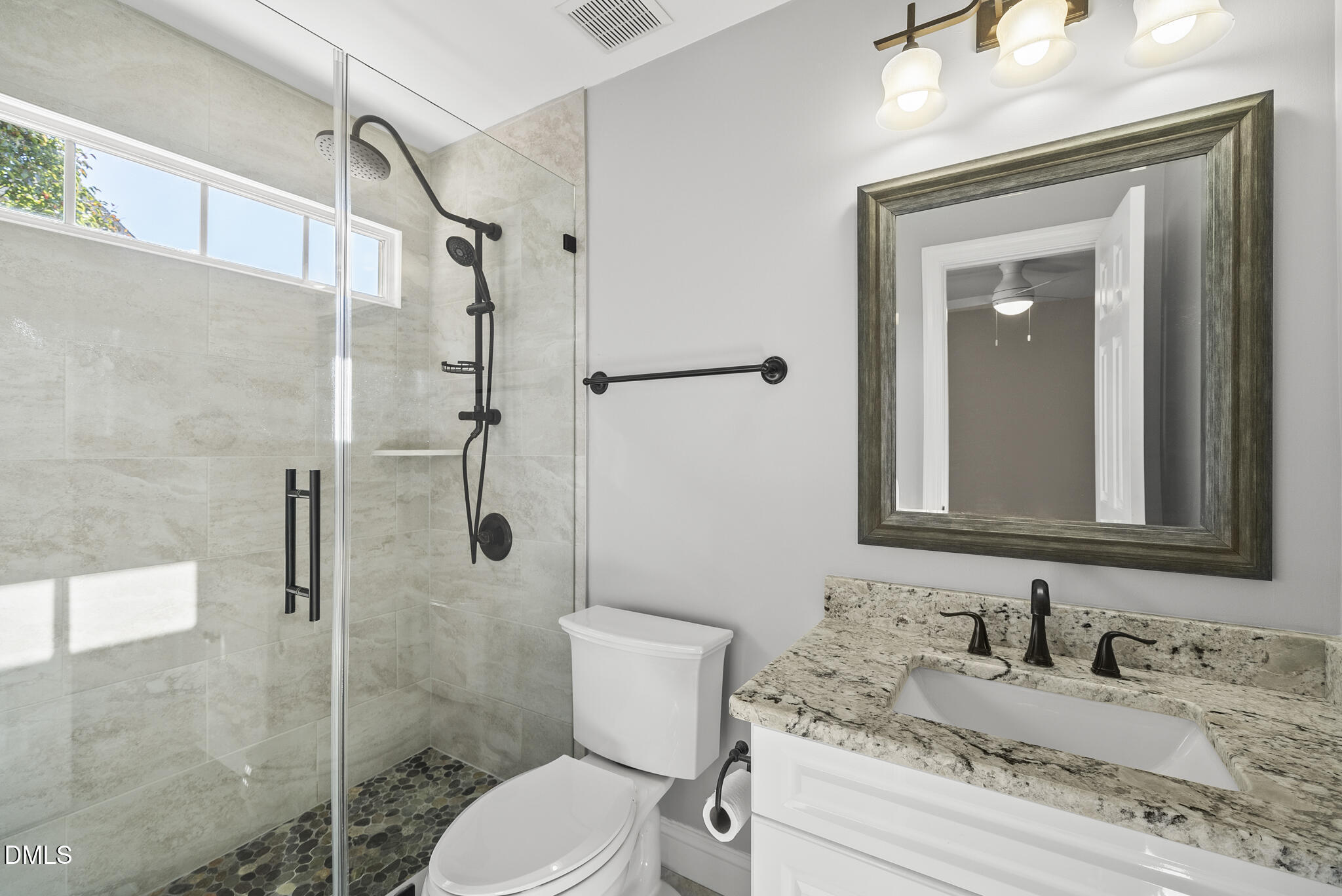 305 Ridge Creek Drive Morrisville, NC 27560 - Photo 23 of 43 a bathroom with a granite countertop toilet sink and shower