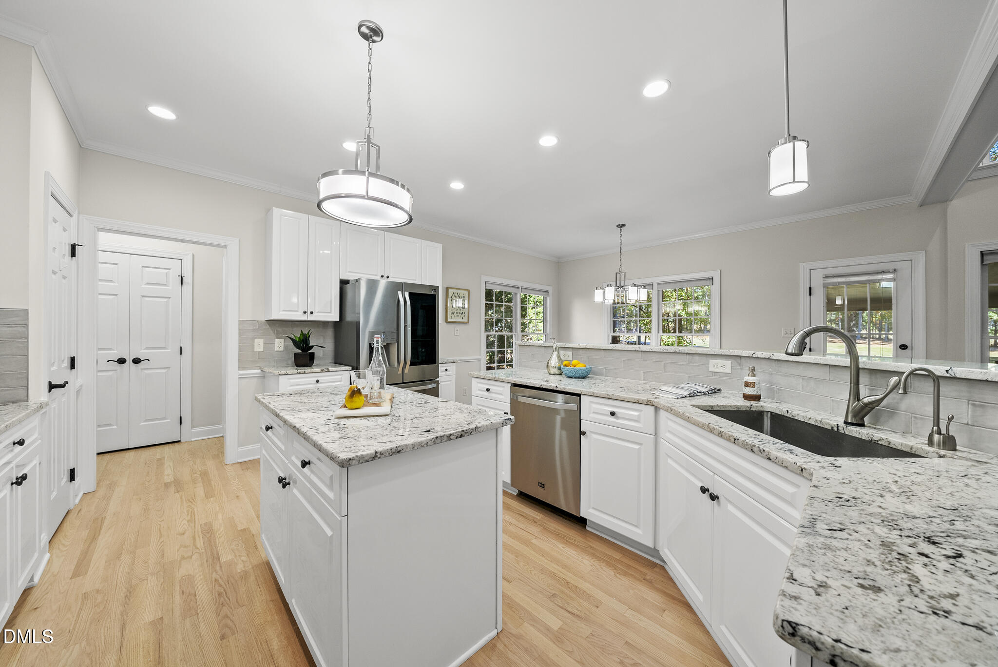 305 Ridge Creek Drive Morrisville, NC 27560 - Photo 10 of 43 a kitchen with stainless steel appliances granite countertop a sink a stove and a wooden floors