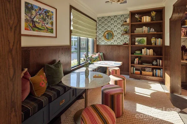 a living room with furniture and book shelf