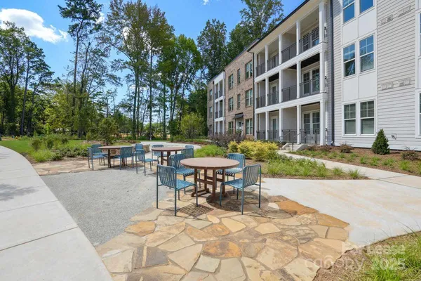 a view of a building with backyard and sitting area