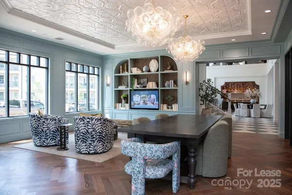 a living room with furniture a table and a fireplace