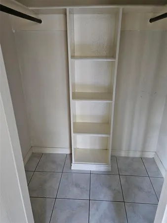 a bathroom with a sink a toilet a mirror and shower