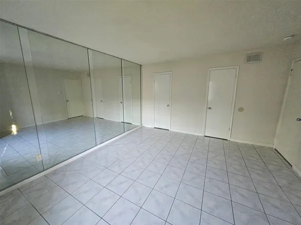 an empty room with windows and entrance