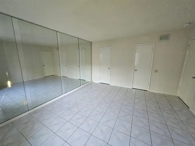 an empty room with windows and entrance
