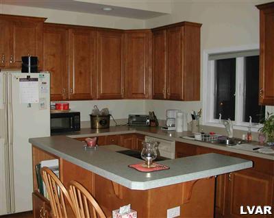 5892 Alexander Road Bethlehem, PA 18017 - Photo 4 of 11 center island, cherry cabinets, downdraft range and flat surface cooktop