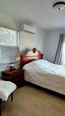 a bedroom with a bed and window
