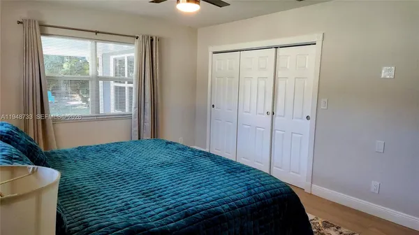 a bedroom with a bed and a window