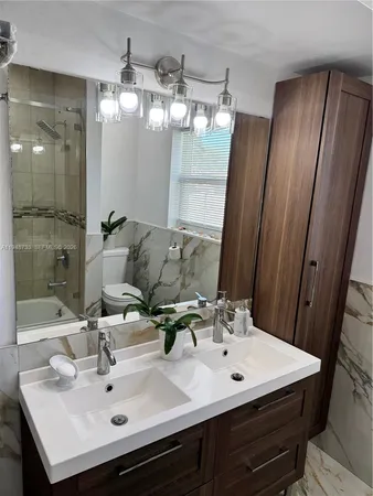 a bathroom with a sink vanity and mirror