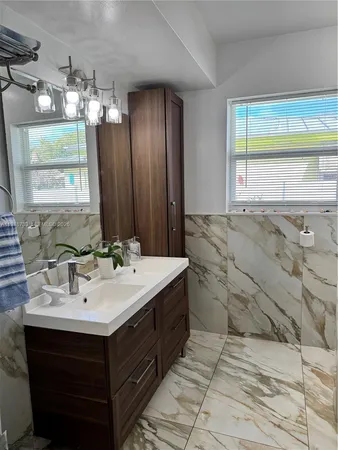a bathroom with a sink vanity and mirror