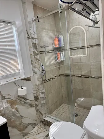a bathroom with a toilet and shower