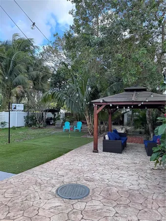 a view of backyard with outdoor seating and green space