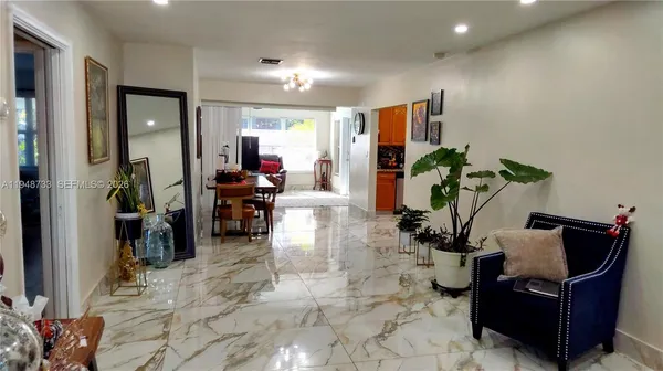 a living room with furniture rug and potted plant