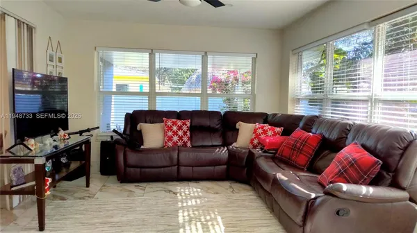a living room with furniture and a flat screen tv