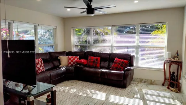 a living room with furniture and a flat screen tv