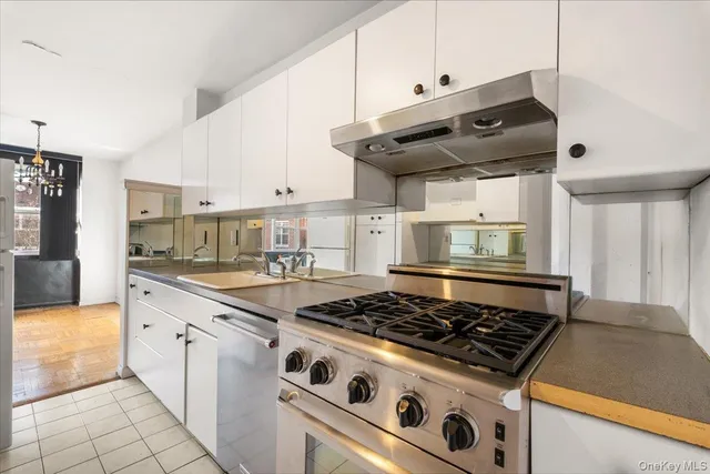 a kitchen with granite countertop a stove and a sink