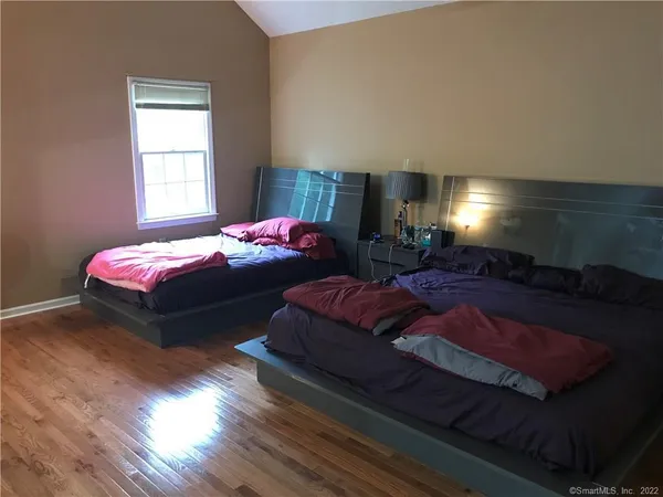a bedroom with bed and window