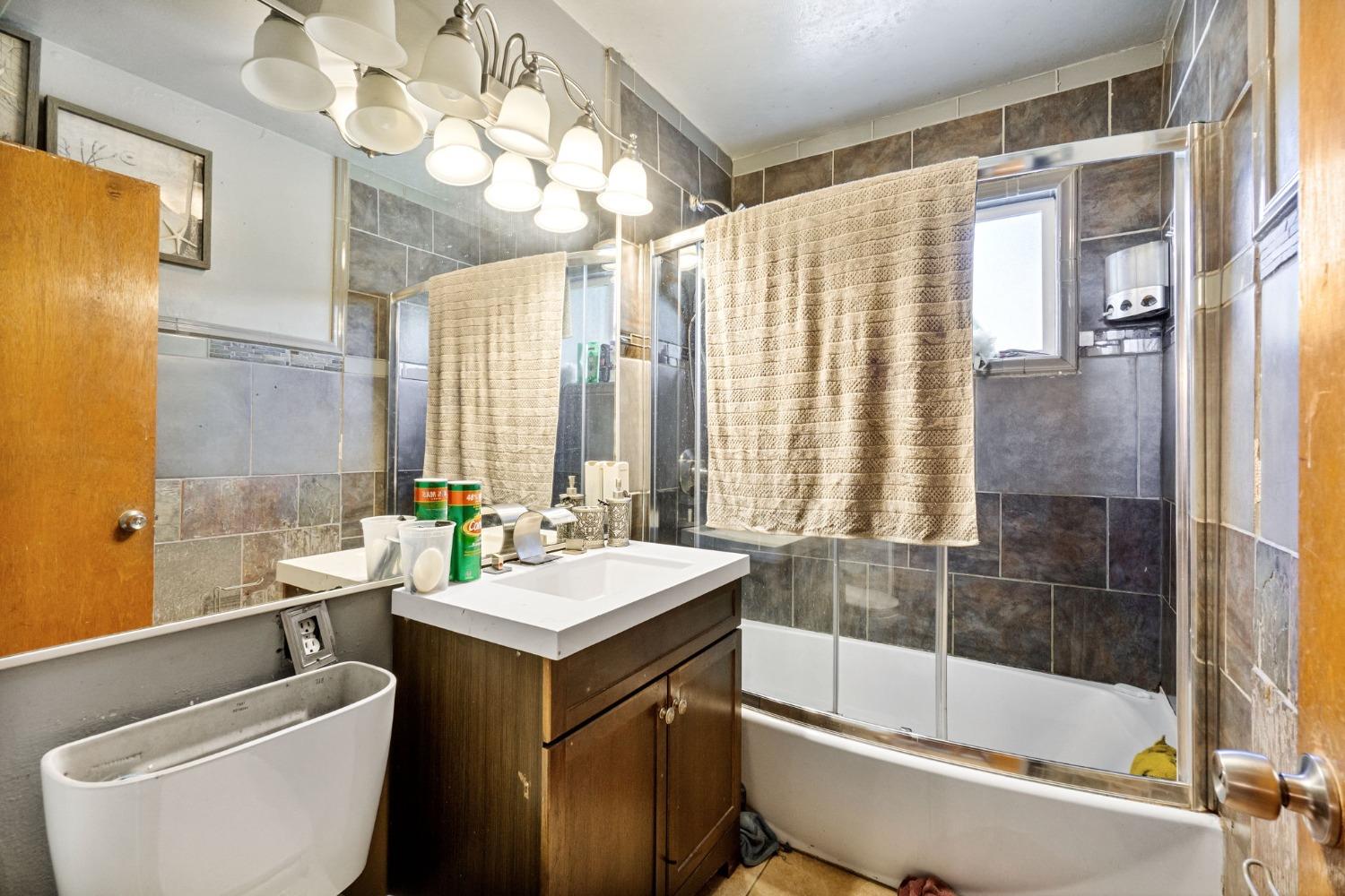 1735 South Maple Avenue Fresno, CA 93702 - Photo 13 of 24 a bathroom with a sink toilet and shower