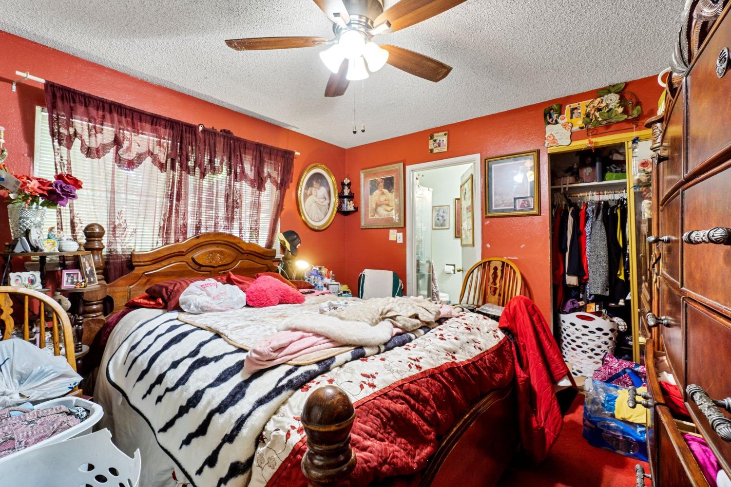 1735 South Maple Avenue Fresno, CA 93702 - Photo 14 of 24 a bedroom with two beds and a chandelier