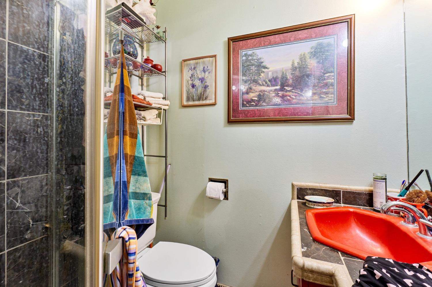 1735 South Maple Avenue Fresno, CA 93702 - Photo 15 of 24 a bathroom with a toilet and shower curtain