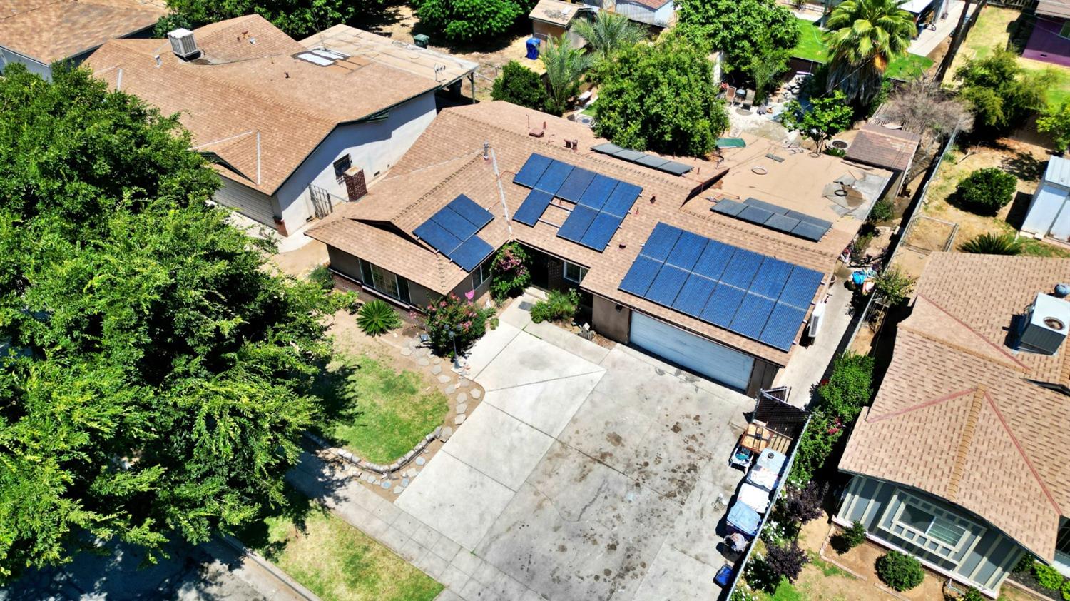 1735 South Maple Avenue Fresno, CA 93702 - Photo 19 of 24 an aerial view of a house with a yard and garden