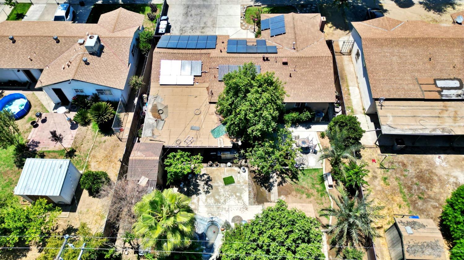 1735 South Maple Avenue Fresno, CA 93702 - Photo 22 of 24 an aerial view of a house with a yard and a wooden deck