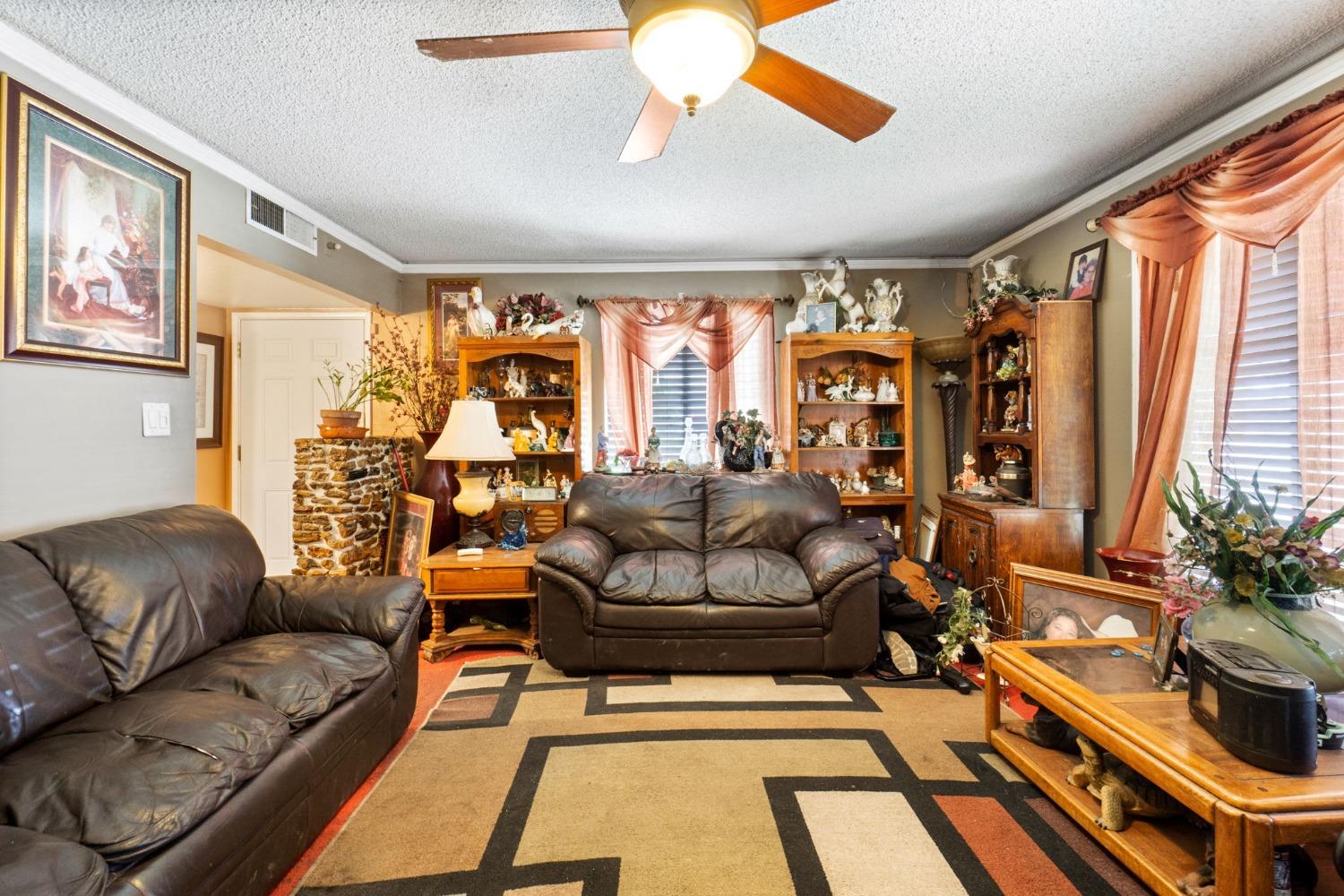 1735 South Maple Avenue Fresno, CA 93702 - Photo 6 of 24 a living room with furniture and a large window