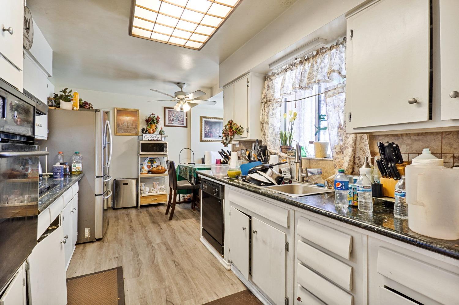 1735 South Maple Avenue Fresno, CA 93702 - Photo 7 of 24 a kitchen with a sink appliances cabinets and a counter top space