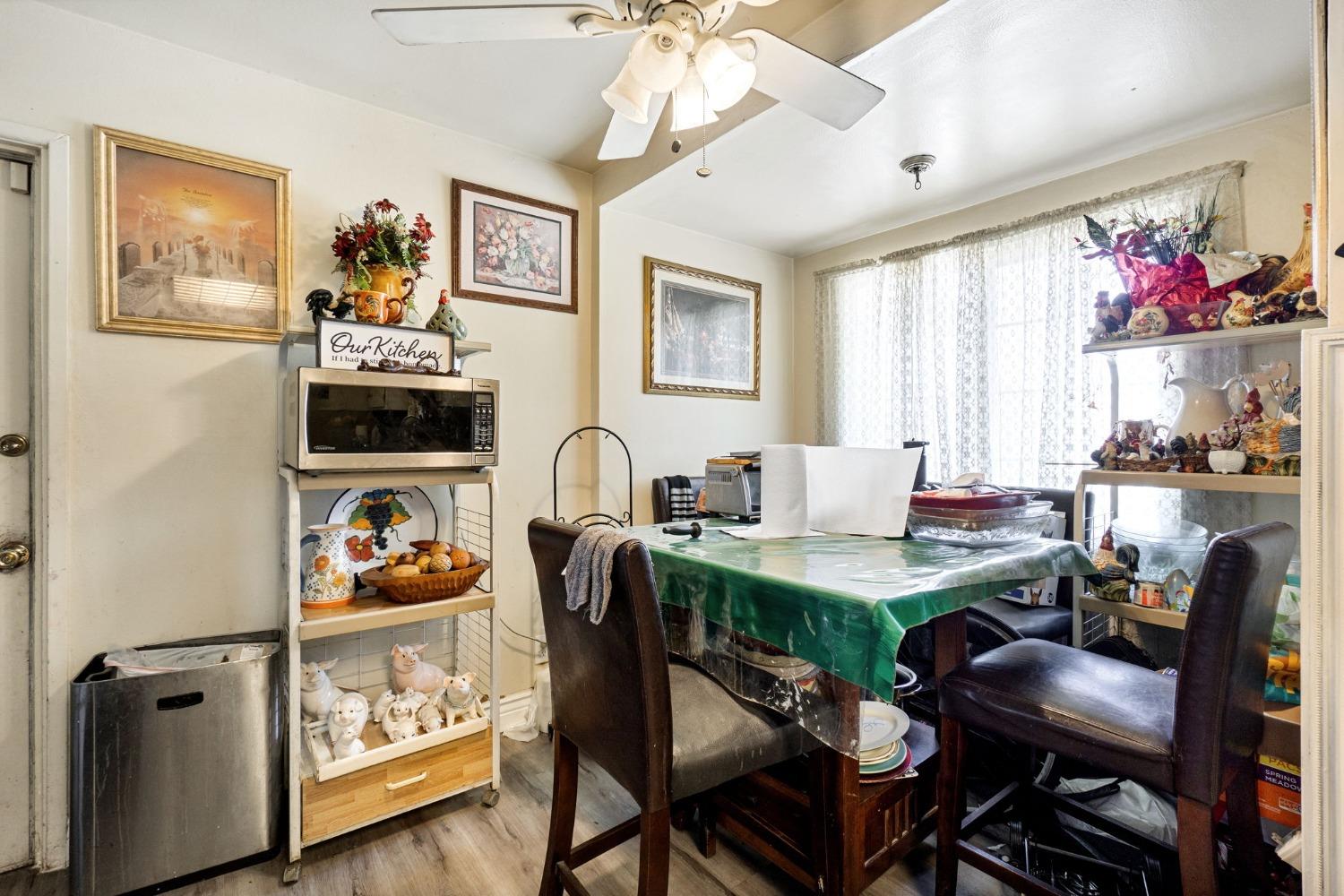 1735 South Maple Avenue Fresno, CA 93702 - Photo 10 of 24 a view of a dining room with furniture a chandelier and a window