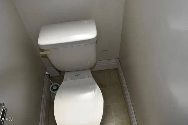 a bathroom with a toilet and a mirror
