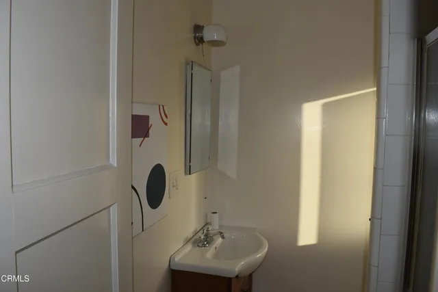 a bathroom with a sink a mirror and shower