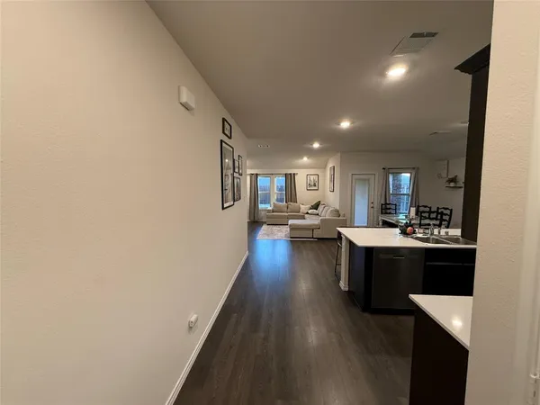 a kitchen with a dining table chairs appliances and cabinets