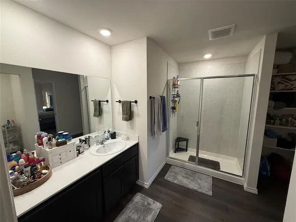 a room with furniture a sink and a mirror