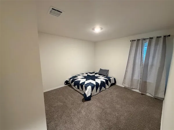 a living room with furniture a rug and a painting