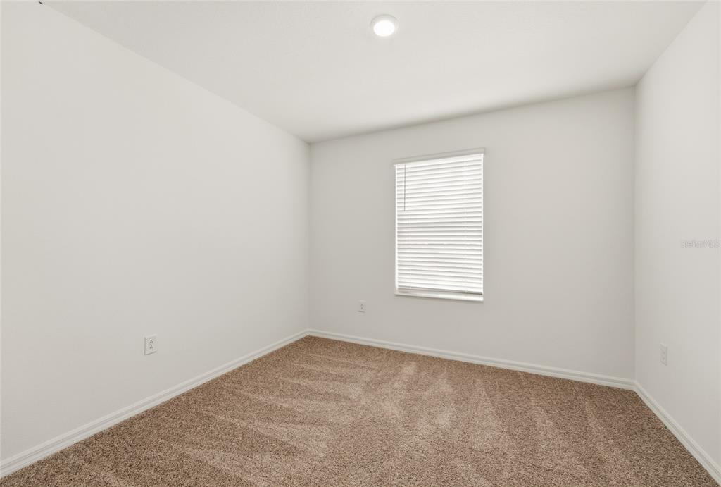 16607 Luminary Loop Clermont, FL 34714 - Photo 15 of 18 an empty room with a window