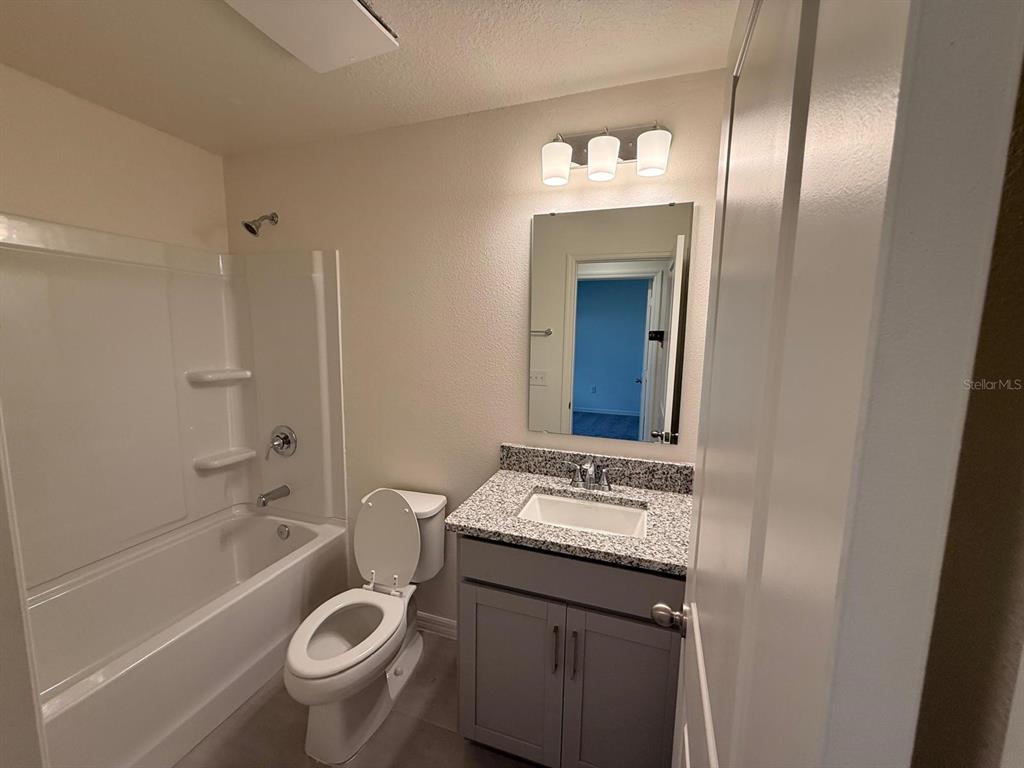 16607 Luminary Loop Clermont, FL 34714 - Photo 16 of 18 a bathroom with a sink a toilet and shower