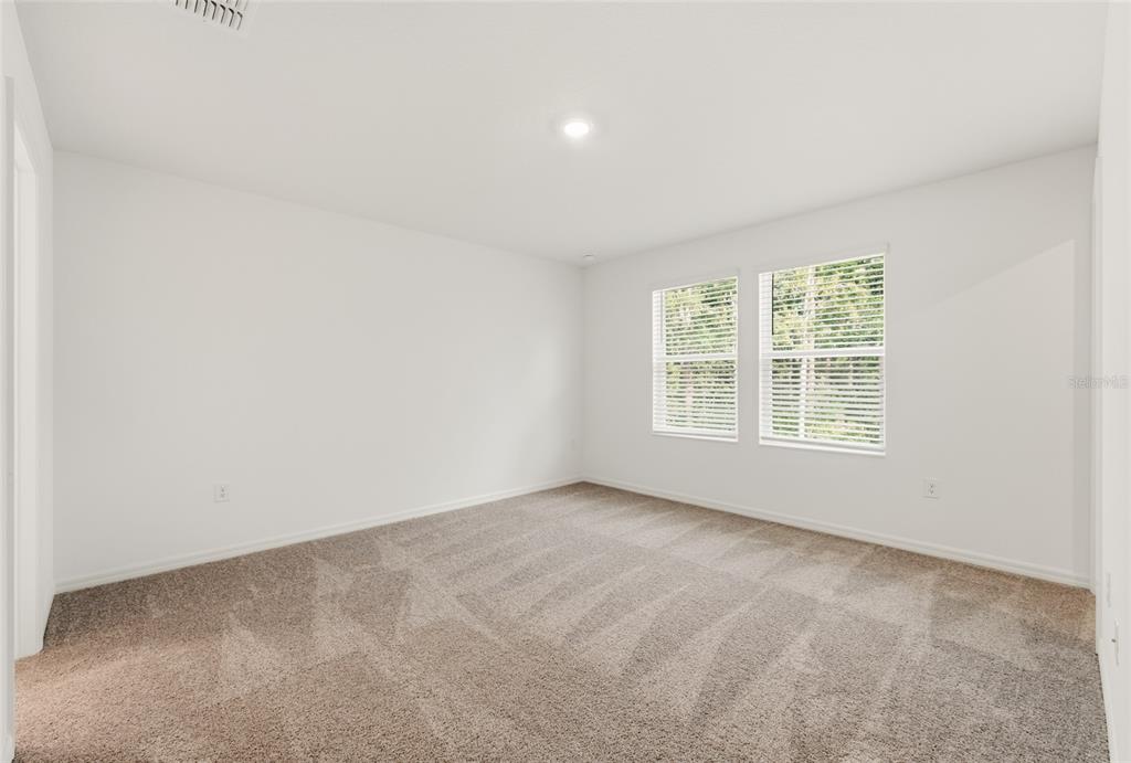 16607 Luminary Loop Clermont, FL 34714 - Photo 8 of 18 an empty room with windows