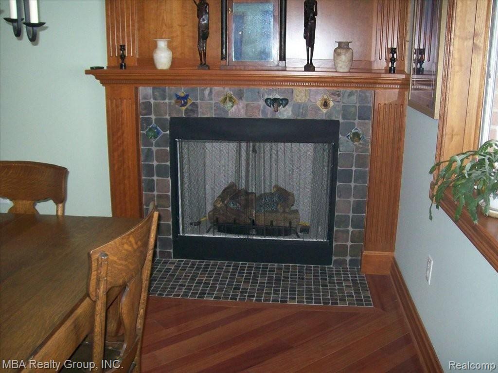 2000 Carleton Rockwood Road Carleton, MI 48117 - Photo 7 of 25 Dining room gas fireplace