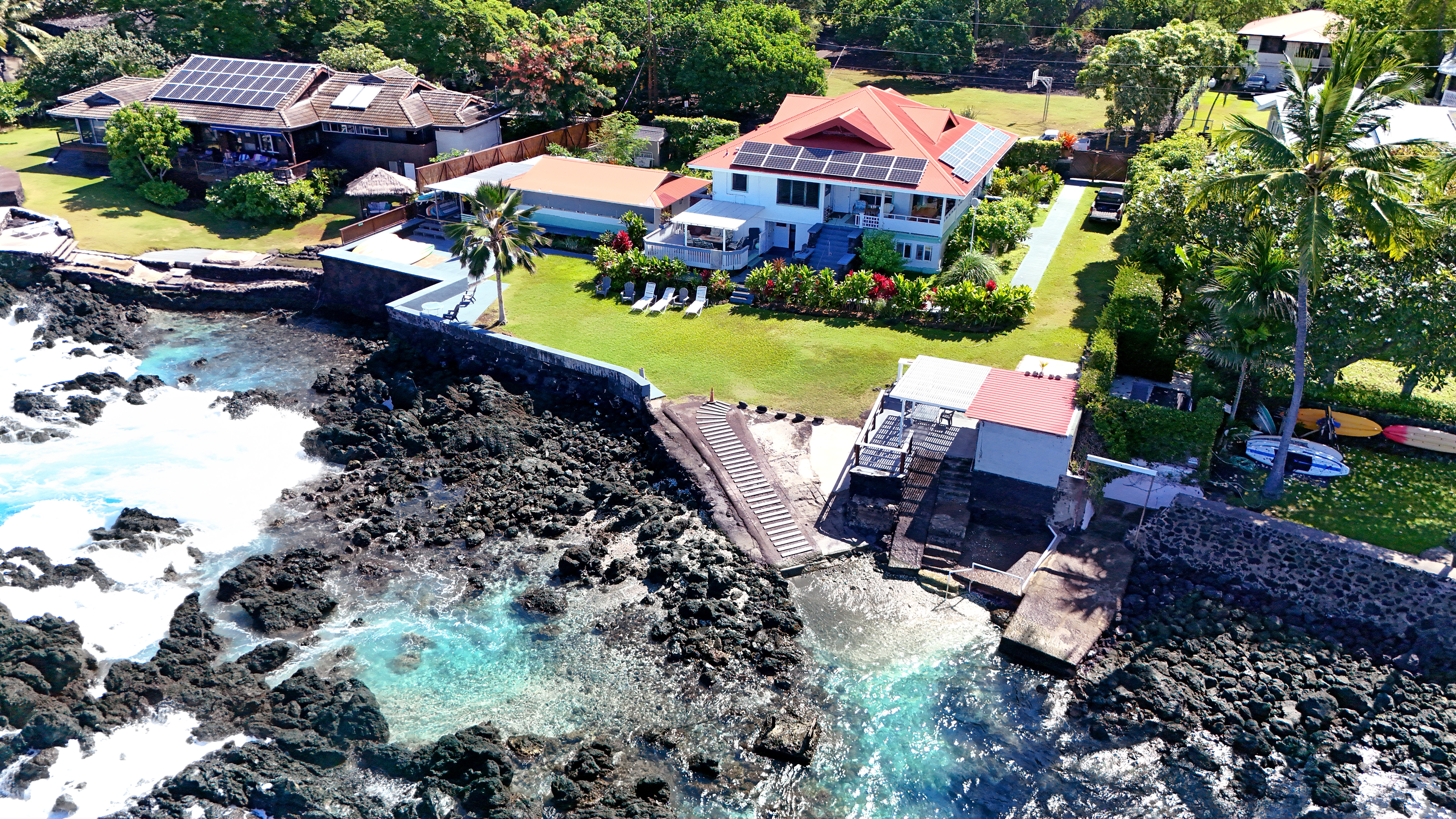 82-6047 Puuhonua Road Captain Cook, HI 96704 - Photo 1 of 25 a view of a house with a yard and garden