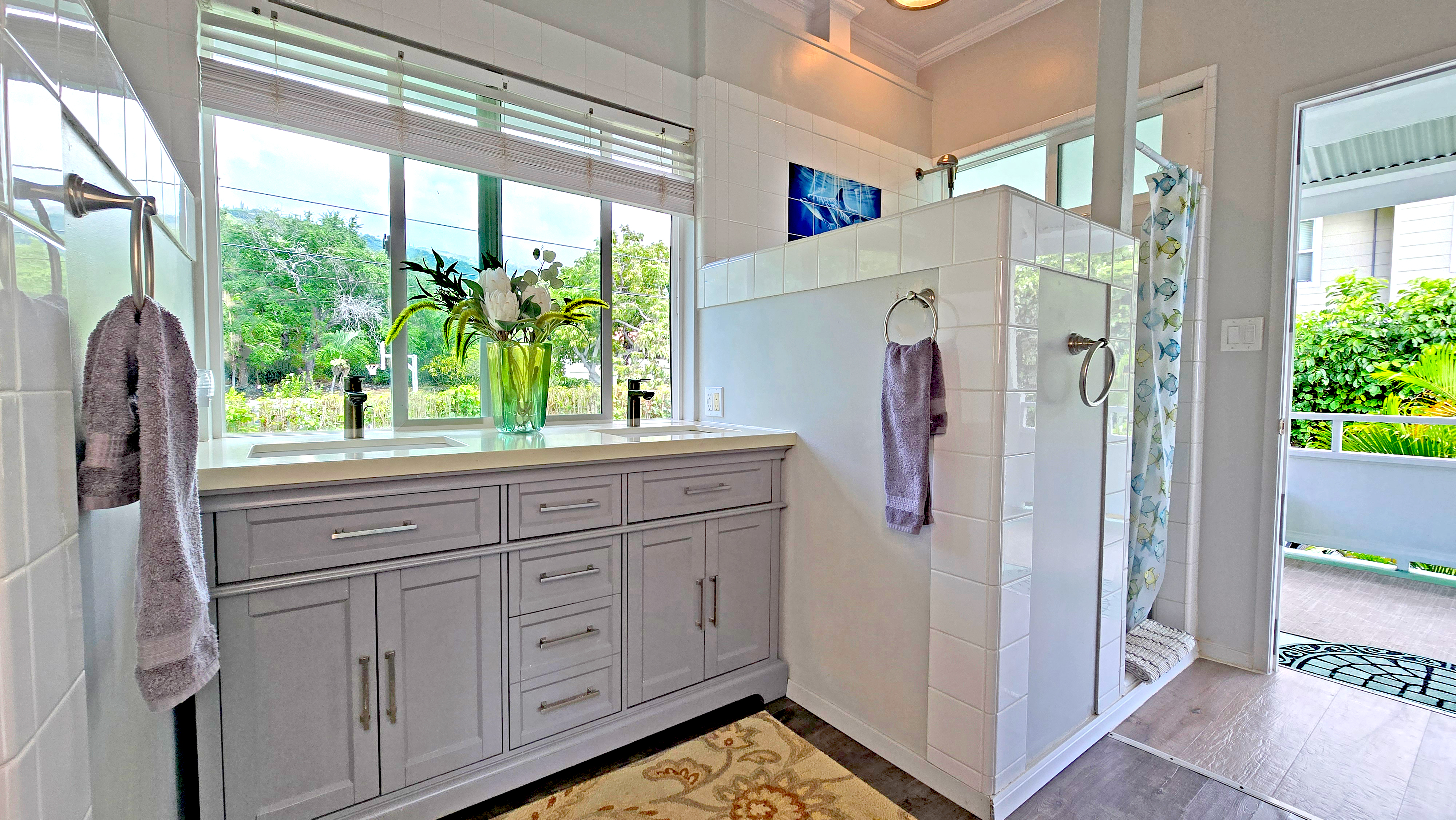 82-6047 Puuhonua Road Captain Cook, HI 96704 - Photo 15 of 25 a bathroom with a double vanity sink and mirror