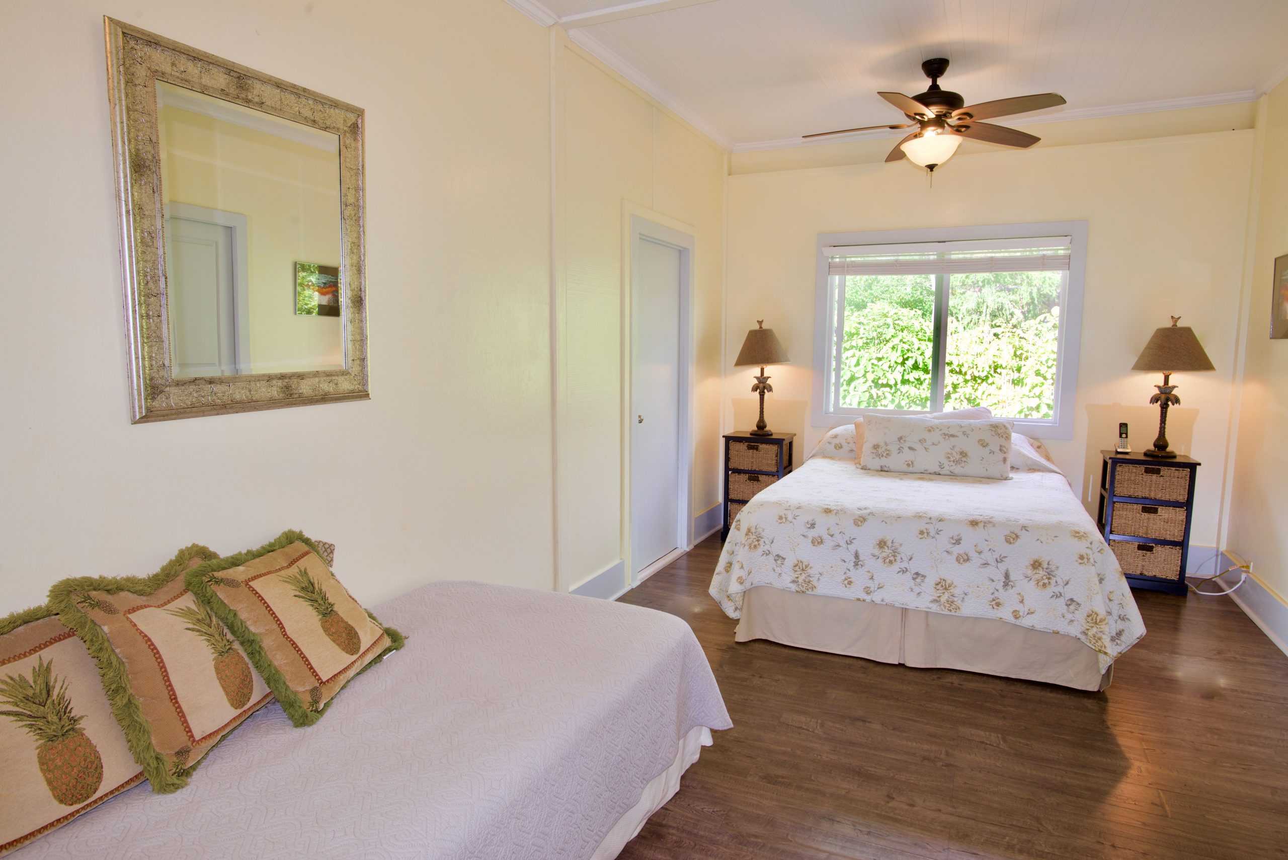 82-6047 Puuhonua Road Captain Cook, HI 96704 - Photo 19 of 25 a bedroom with a bed and wooden floor