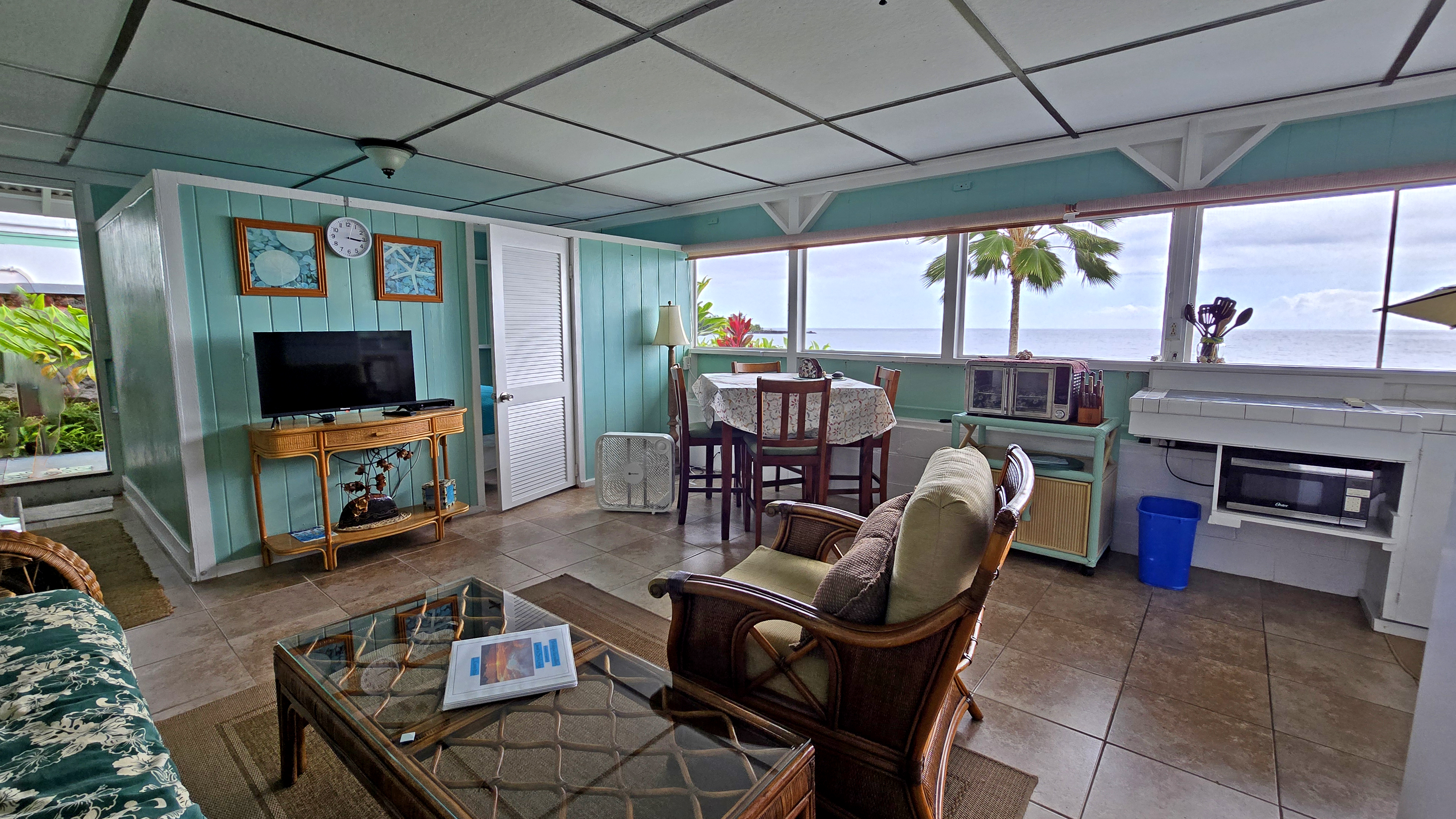 82-6047 Puuhonua Road Captain Cook, HI 96704 - Photo 21 of 25 a living room with furniture a flat screen tv and a fireplace