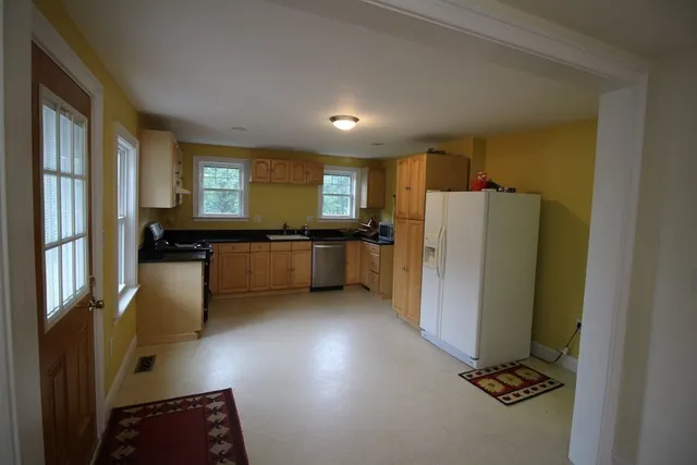 a kitchen with a refrigerator and a stove