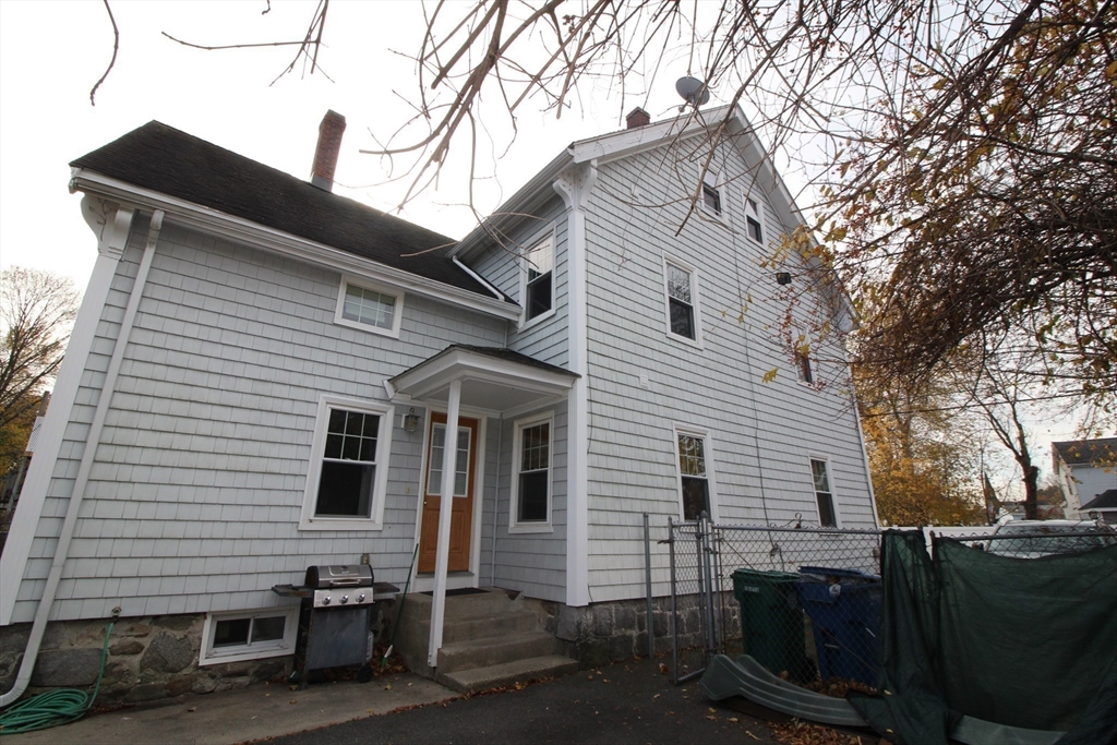 4 Wilson Street, Unit LEFT Billerica, MA 01862 - Photo 26 of 29 a view of a house with a yard