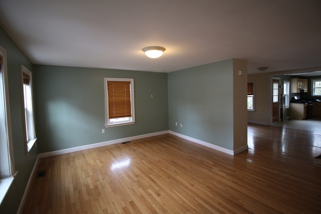 4 Wilson Street, Unit LEFT Billerica, MA 01862 - Photo 6 of 29 wooden floor in an empty room with a window