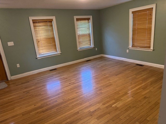 4 Wilson Street, Unit LEFT Billerica, MA 01862 - Photo 7 of 29 a view of an empty room with wooden floor and a window