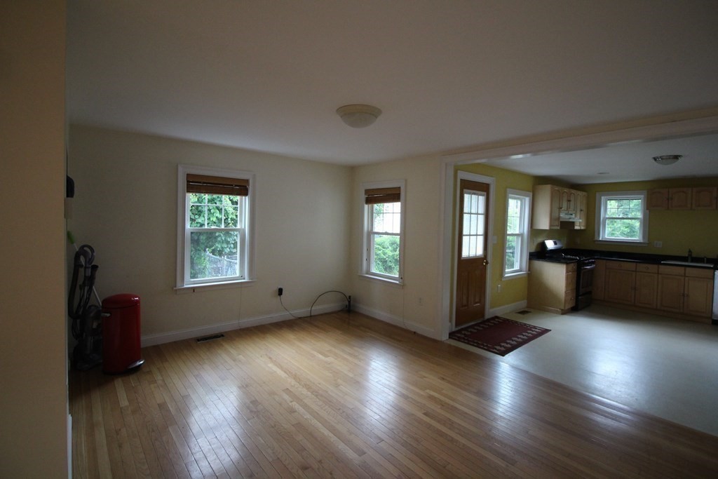 4 Wilson Street, Unit LEFT Billerica, MA 01862 - Photo 9 of 29 a view of an empty room with a window and wooden floor