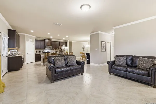 a living room with furniture and kitchen view