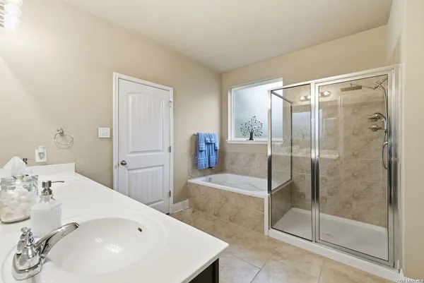 a bathroom with a shower sink and mirror